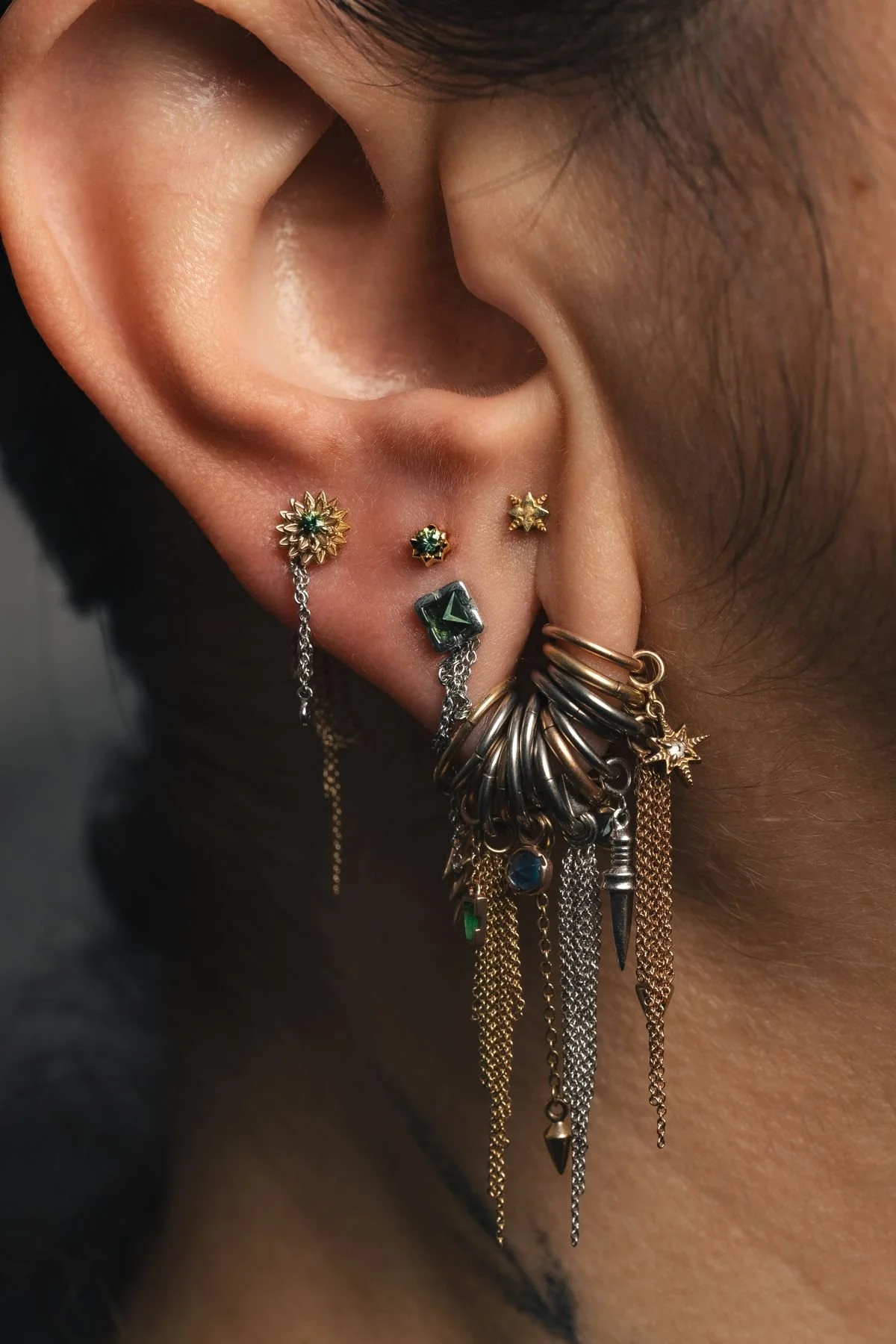 Detailed ear jewelry stack photographed for a brand campaign