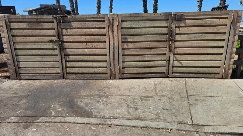 Concrete walkway and gates before pressure washing, stained and grimy