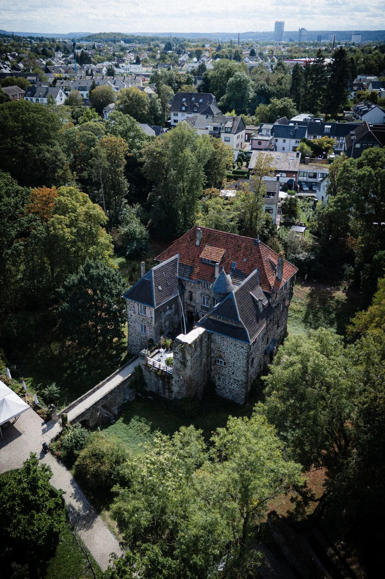 Aerial view of Burg Lede surrounded by trees