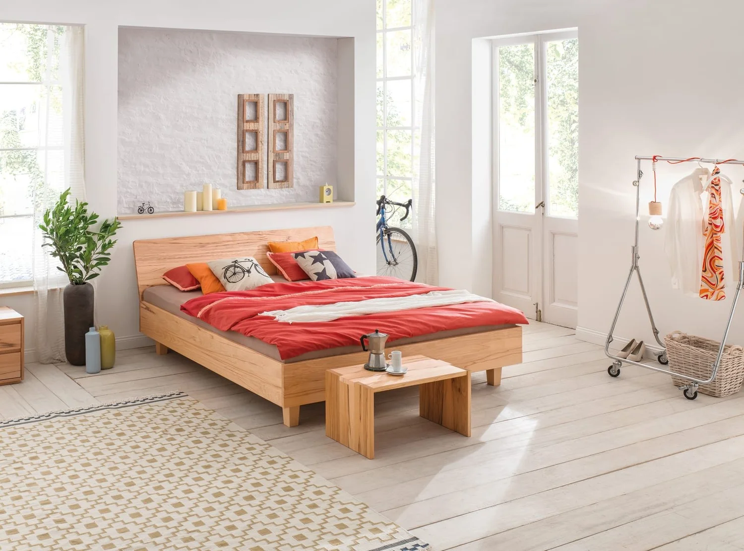 Dormiente Kanda solid beech bed with red bedding