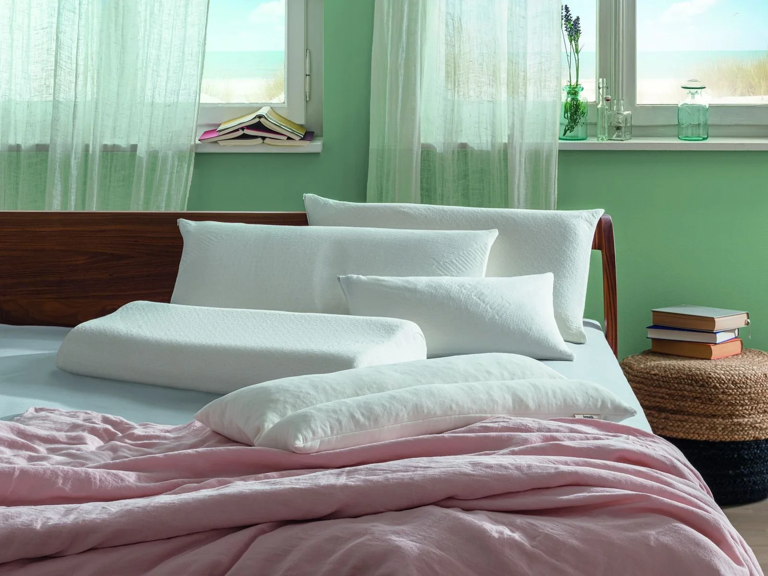 Natural filled pillows on a made-up bed