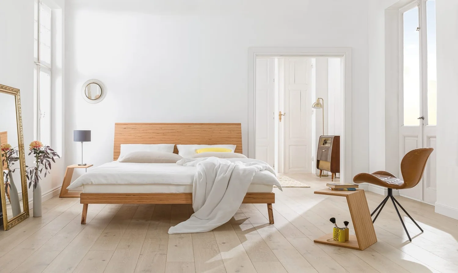 Dormiente Laria low-profile solid wood bed in a white bedroom