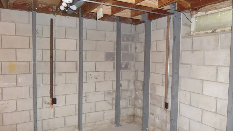 Steel tube braces. Note the count, the spacing, whether they are grouted tight behind, and any movement between them.