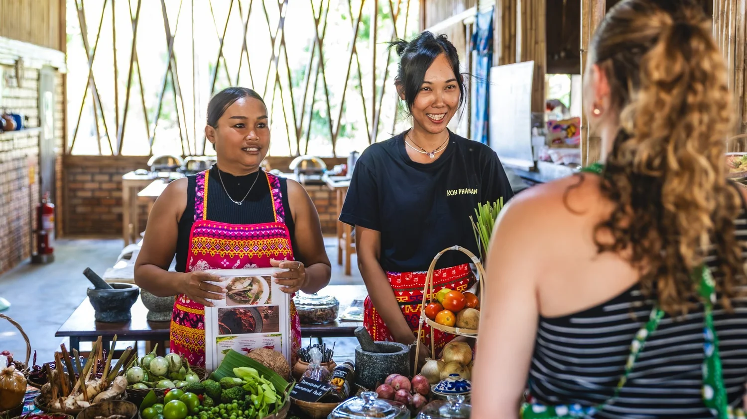 Thanita and her colleague welcoming students at Proud Home, Koh Phangan