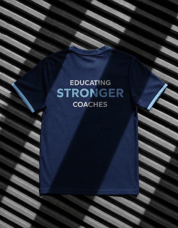 Back of the navy shirt reading Educating Stronger Coaches.