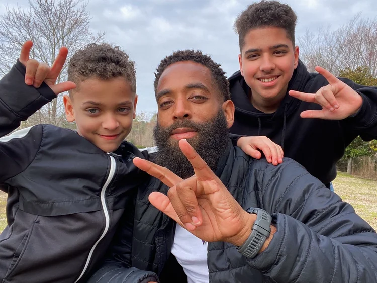 A father outdoors with his two sons