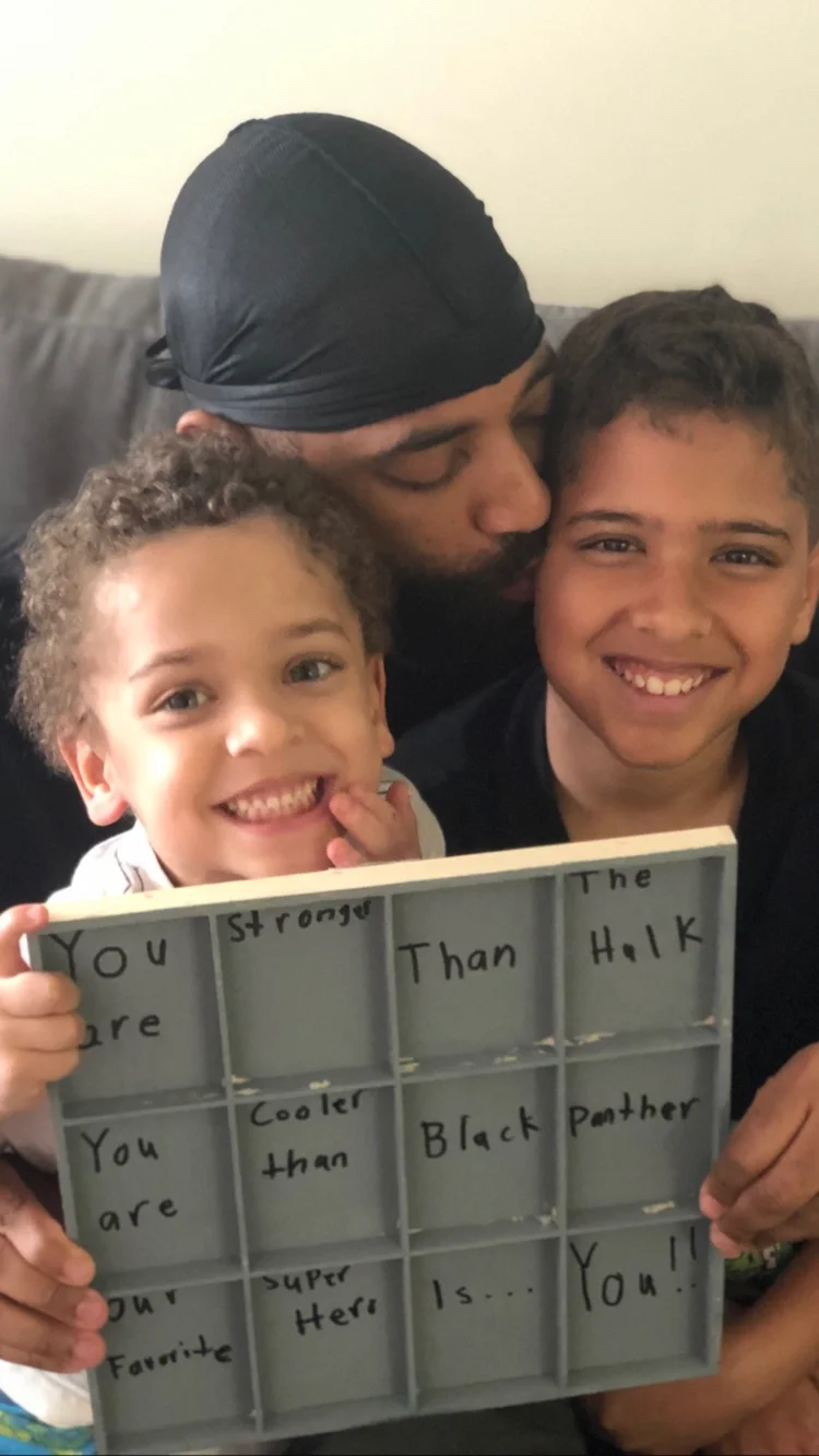 A father with both sons and a handmade card