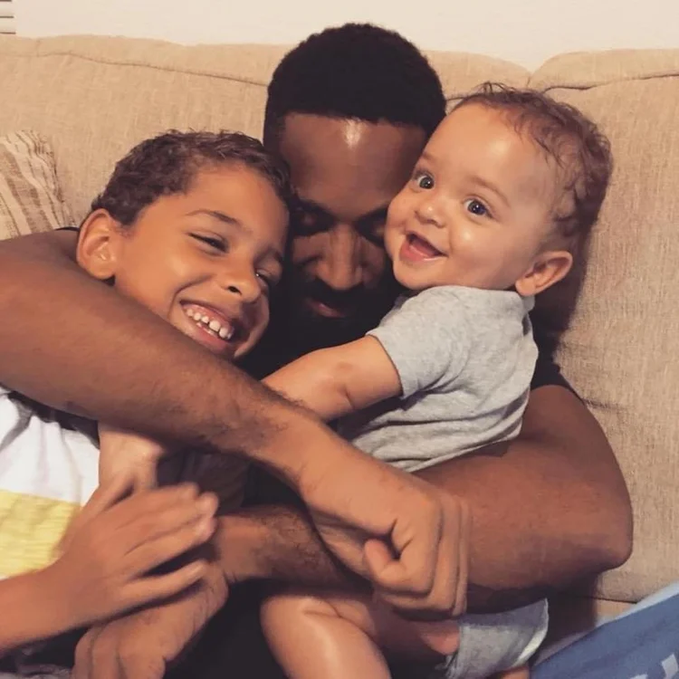 A father resting with his two sons