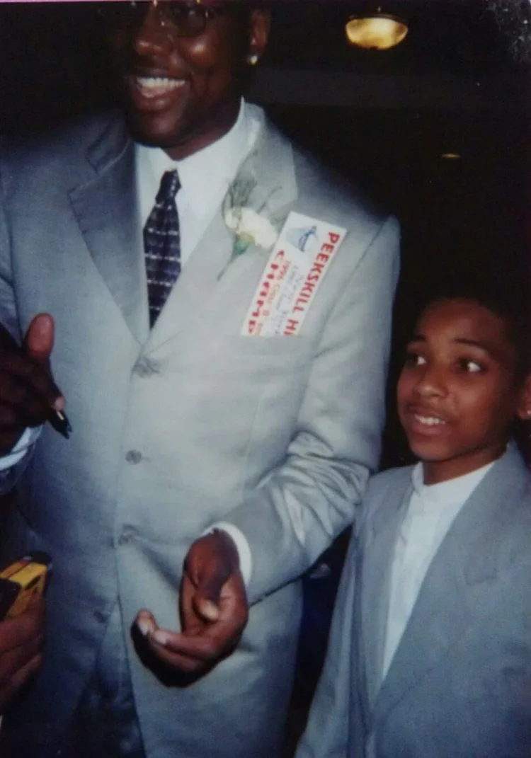 Rashad Houston as a boy beside Elton Brand, his mentor and camp counselor from Peekskill.