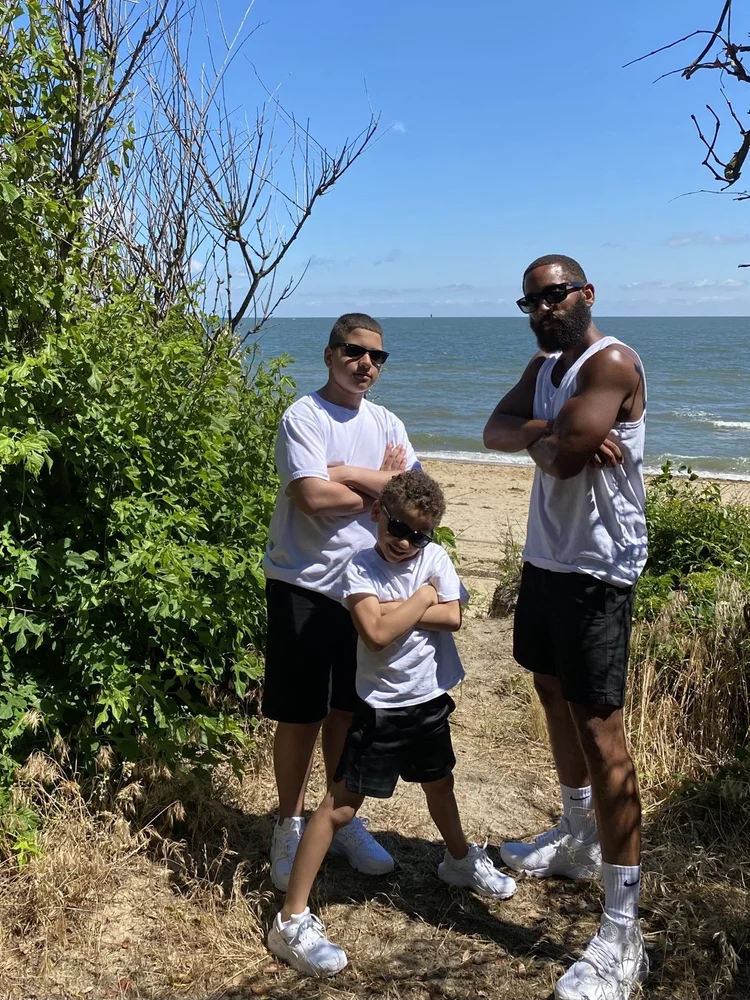 A father and his sons at the beach