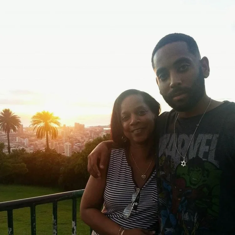 With Mom beneath palms at sunset