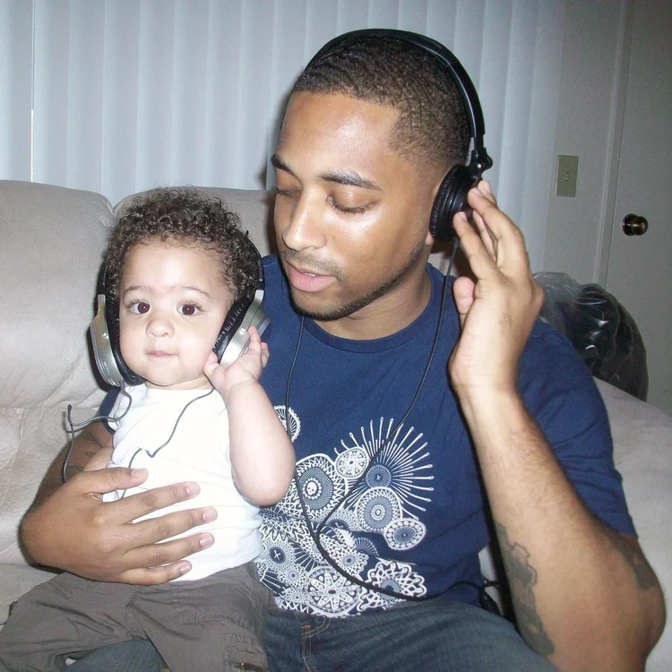 A father and child sharing headphones
