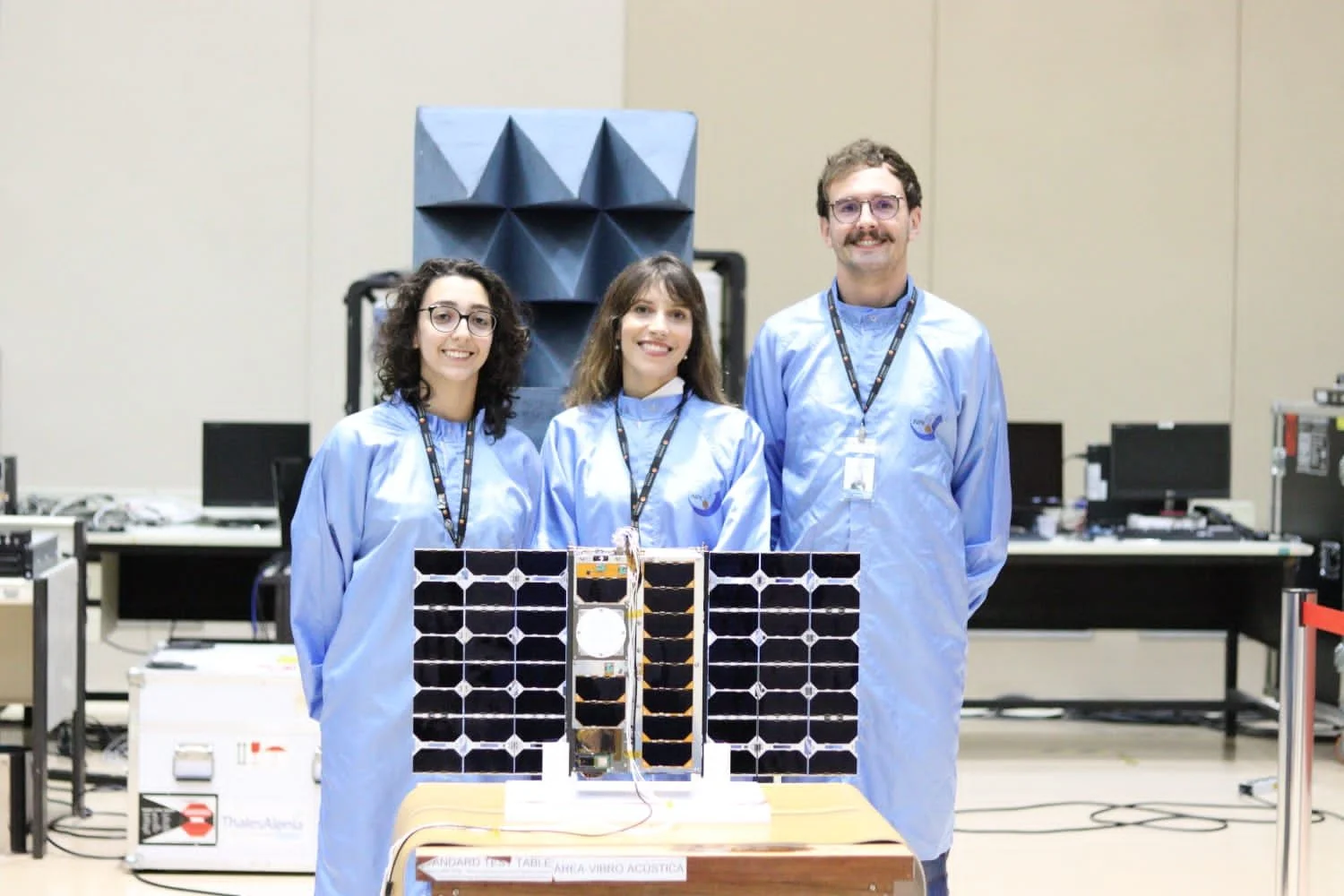 Mariana Barbosa and two colleagues beside their satellite