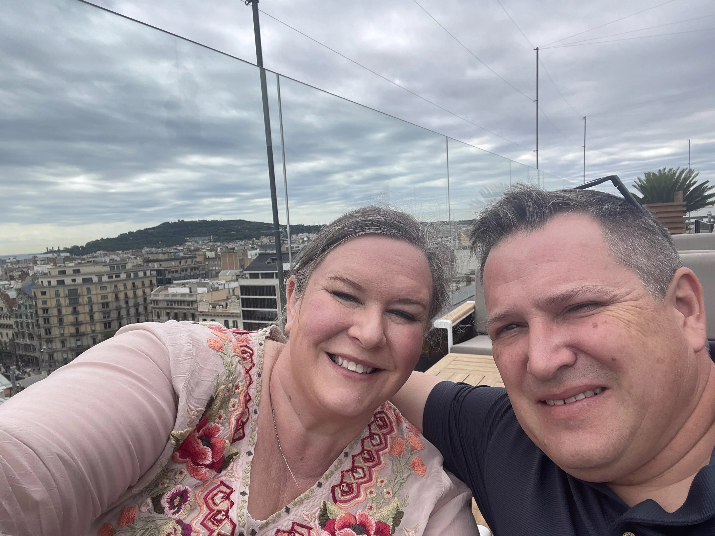 Rooftop selfie with the city behind us.