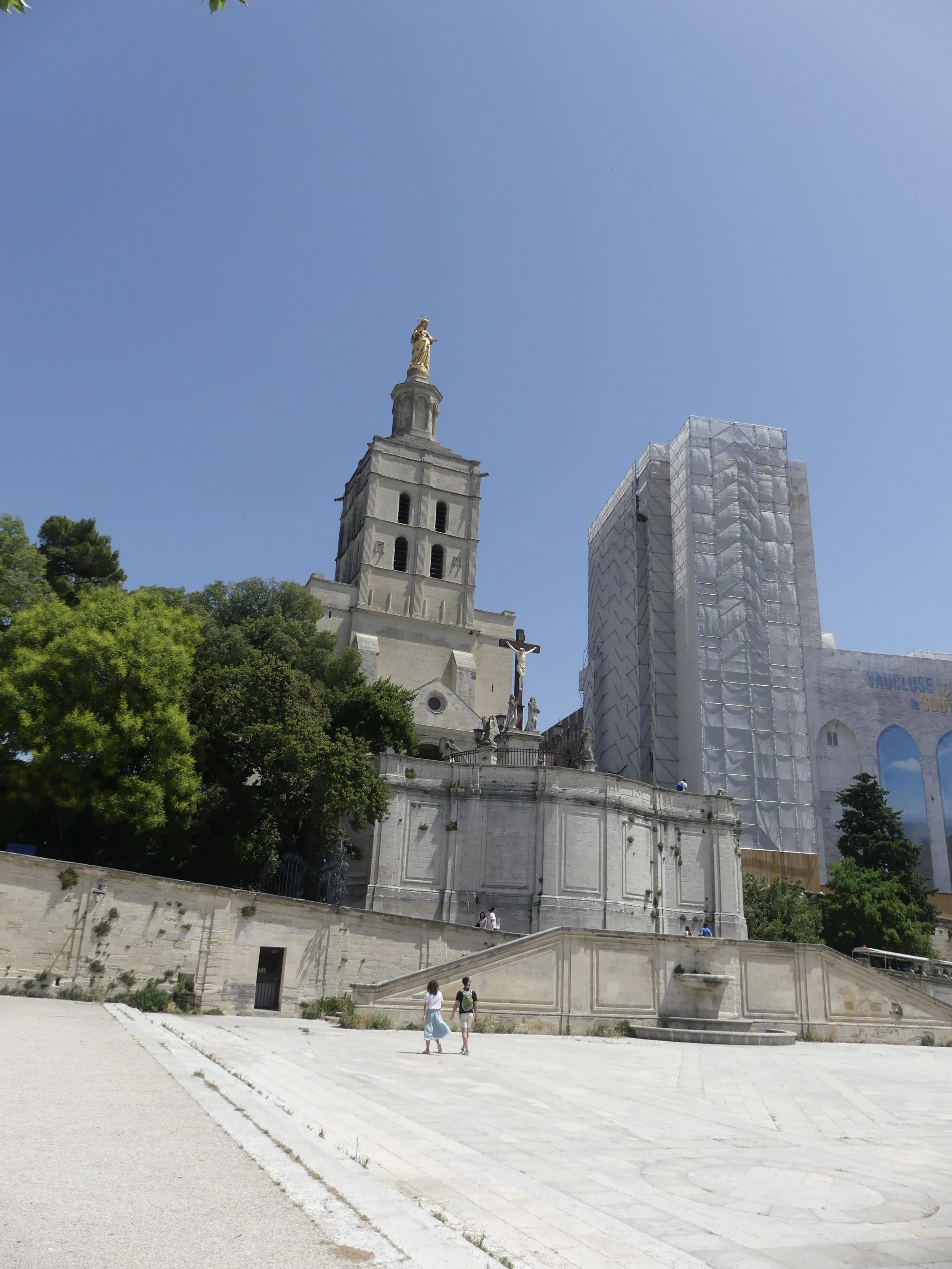 The Palais des Papes plaza, cathedral tower and golden statue.