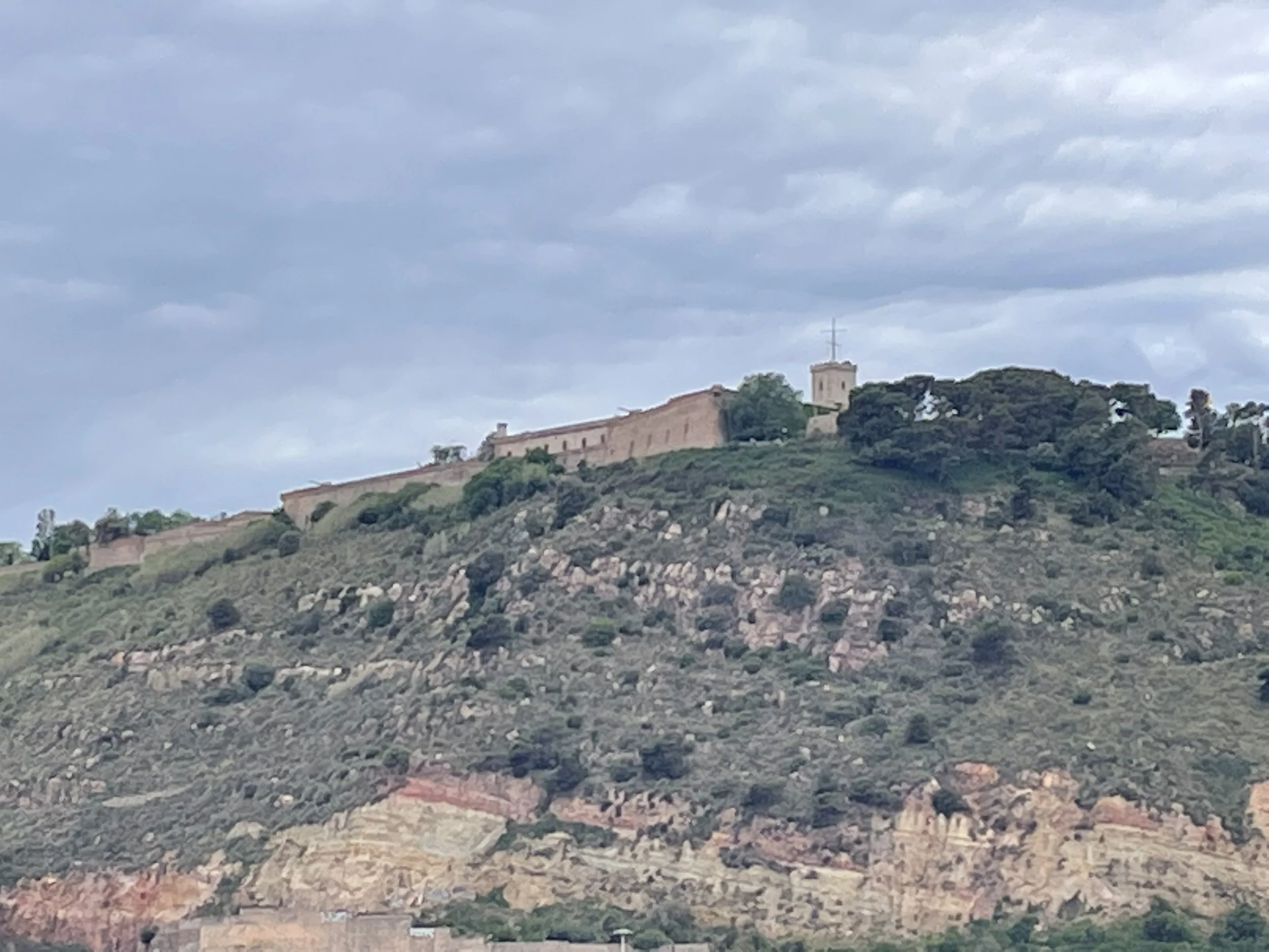 A fortress-crowned hill on the horizon.