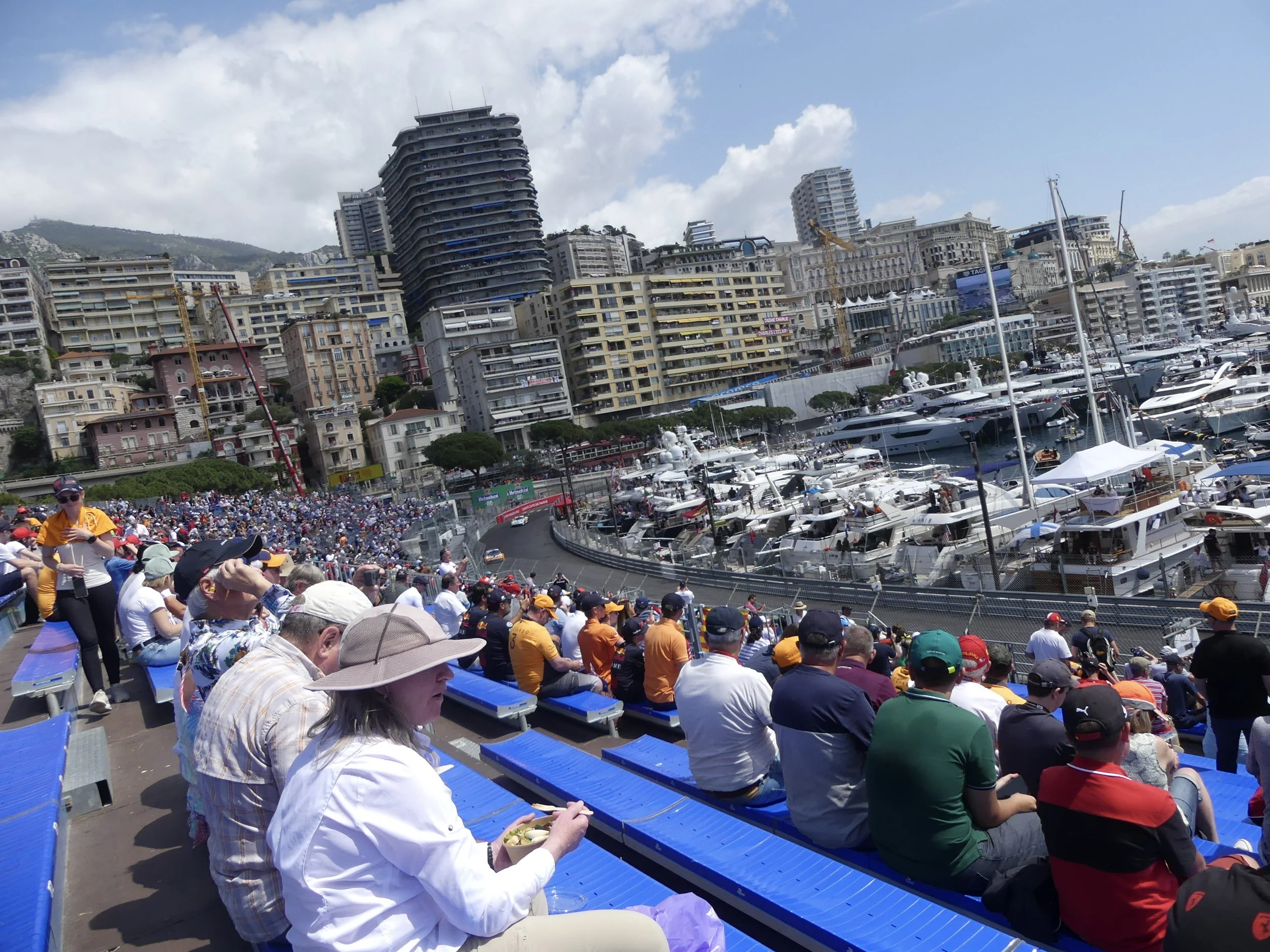 From the grandstand: the harbor circuit, yachts, and Monte Carlo rising behind.