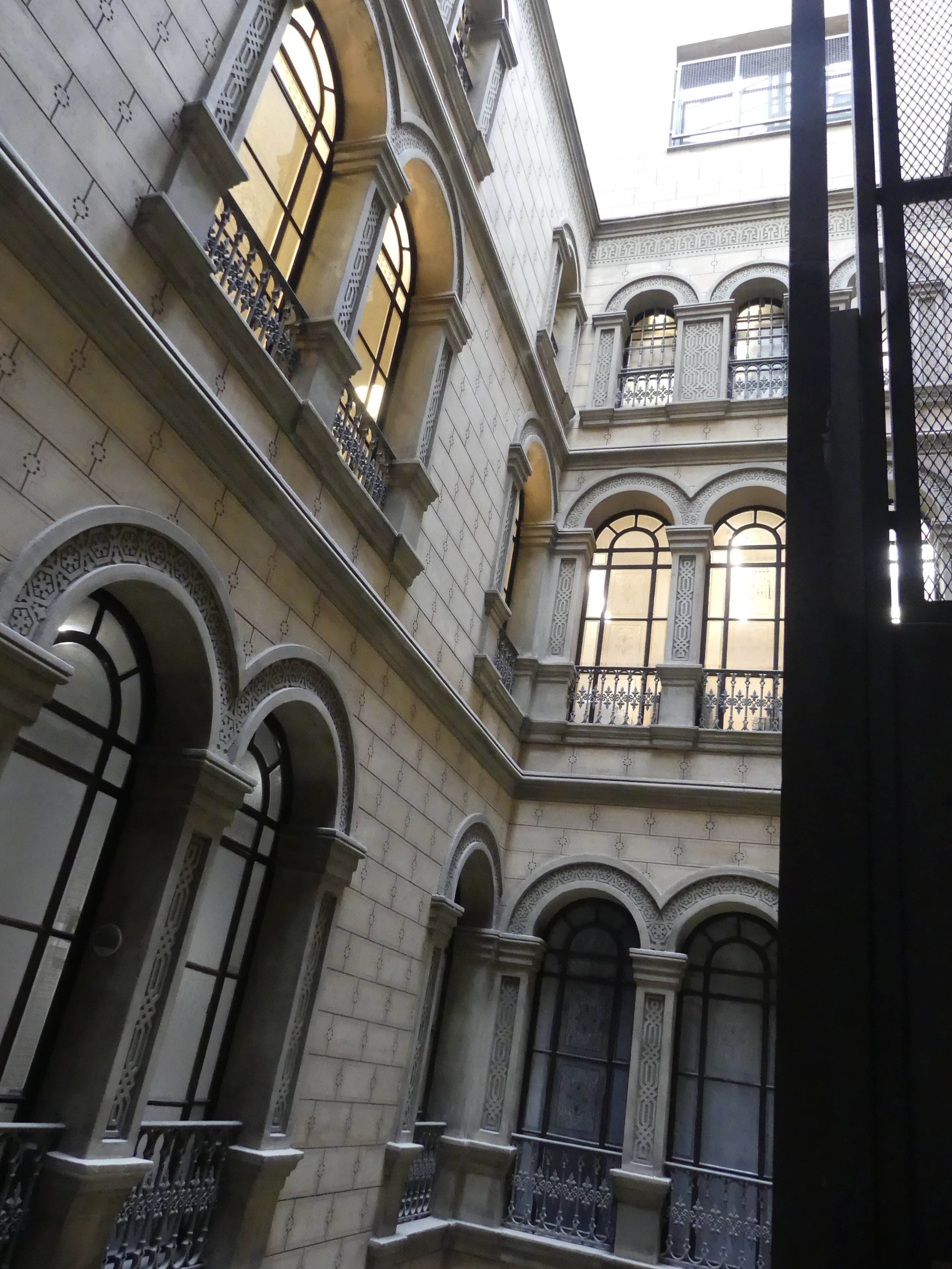 Arched windows and balconies around an interior courtyard.