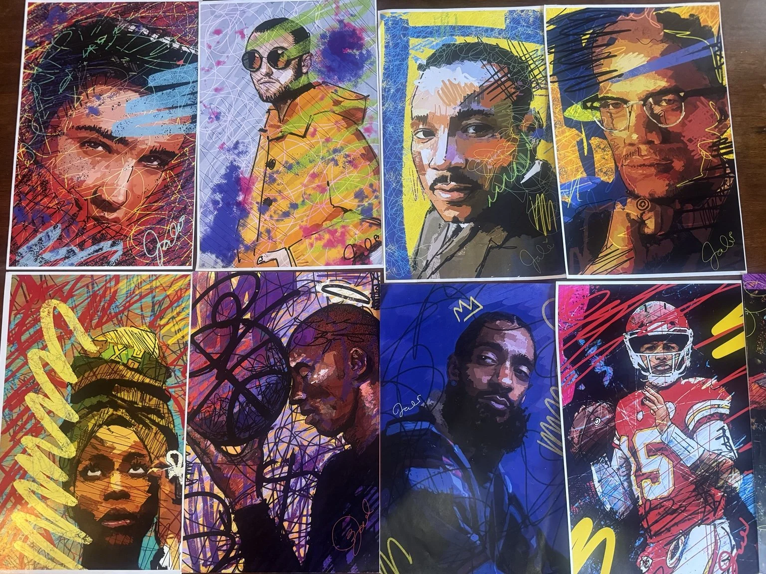 A group of colorful portrait prints by Jasmine Ali arranged together.