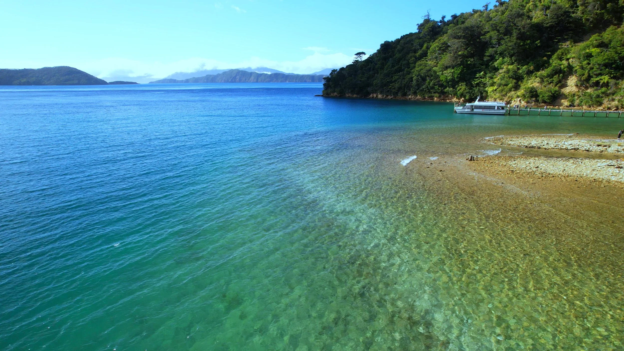 Clear water and a Beachcomber boat in a Marlborough Sounds bay