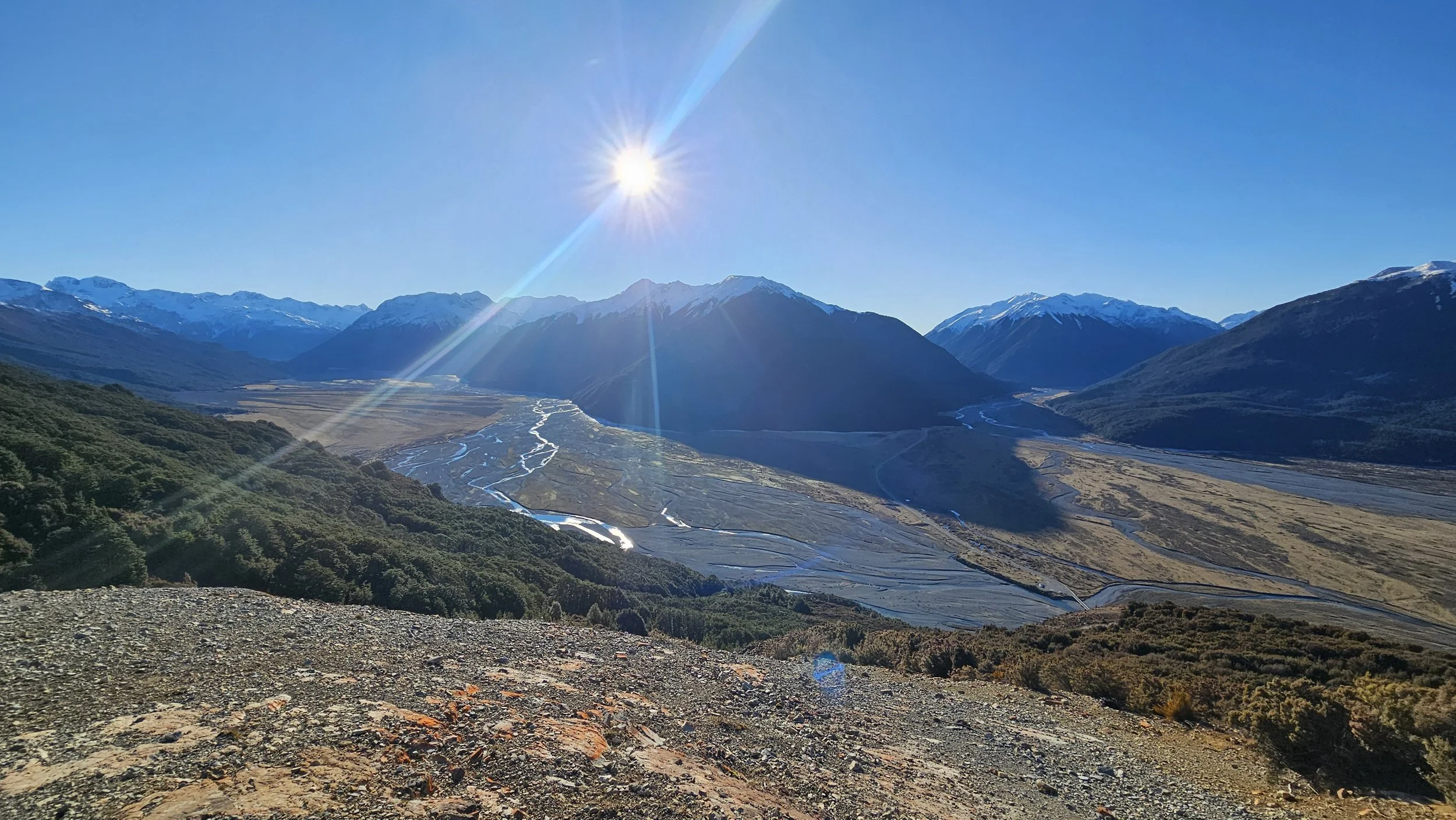 Sunlight over the mountains and braided river valleys from Bealey Spur