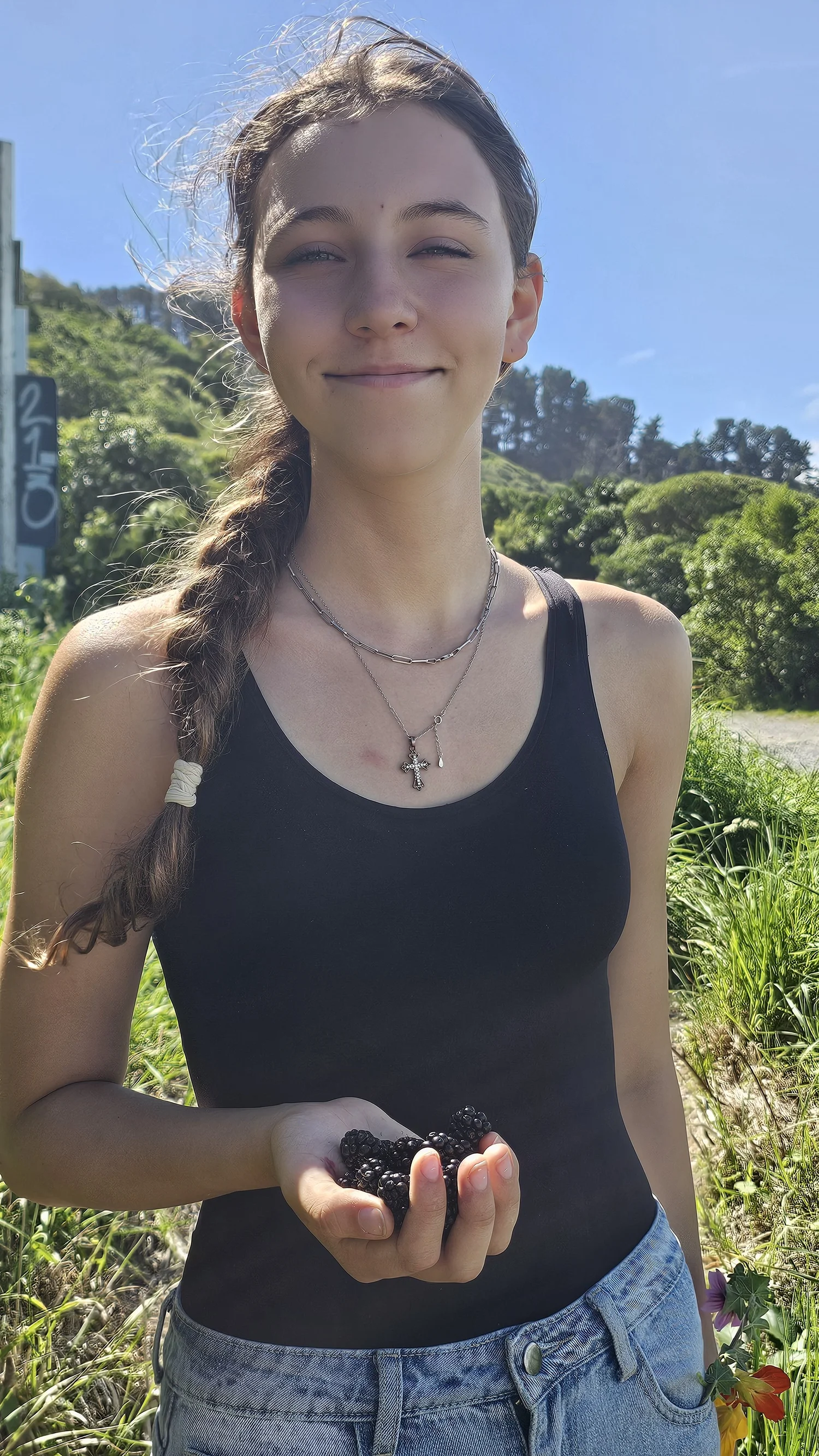 Malaya holding wild blackberries near Gore Bay