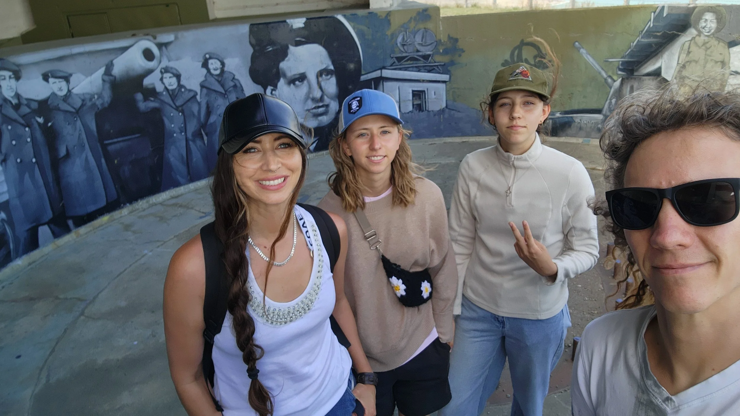 Our family beside a wartime mural at Godley Head