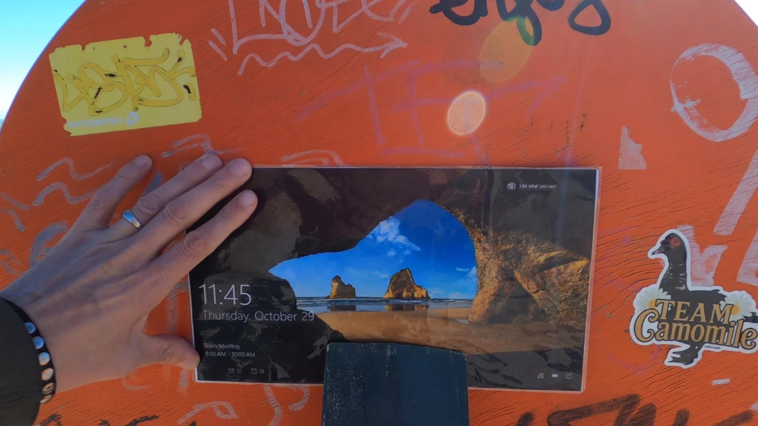 Windows lock-screen image of Wharariki Beach displayed at the beach
