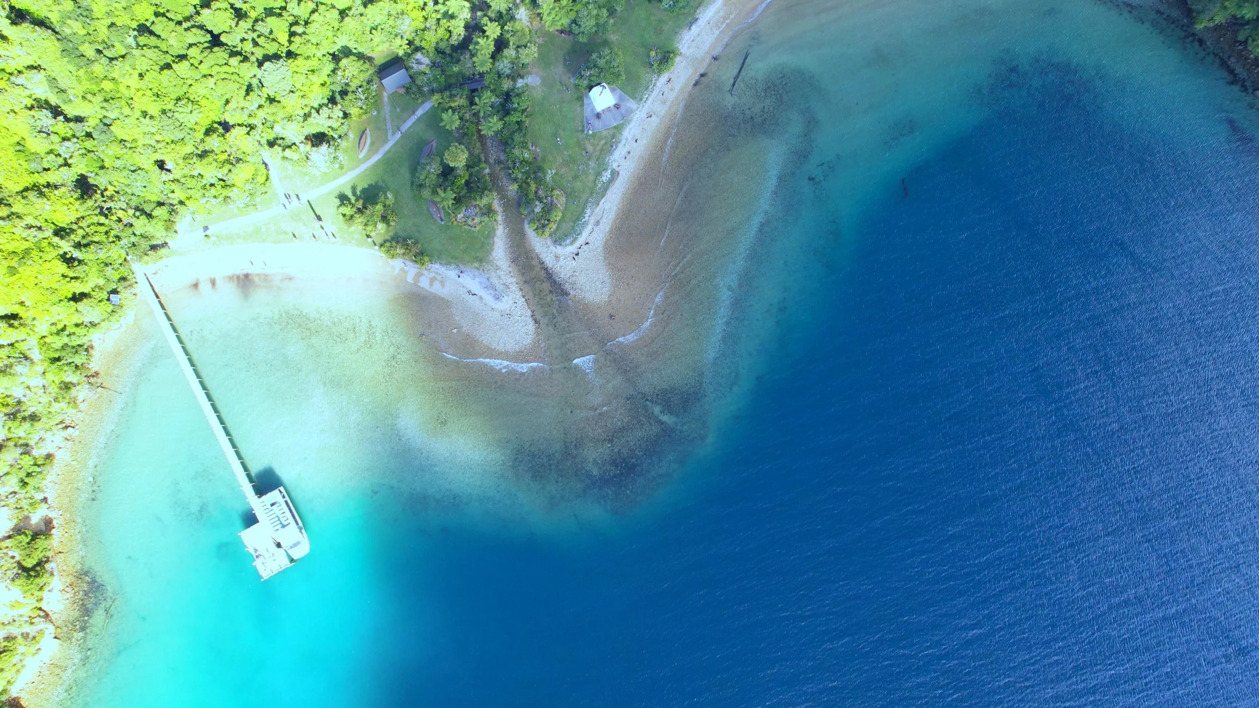 Beachcomber vessel in clear water beside a remote Marlborough Sounds bay