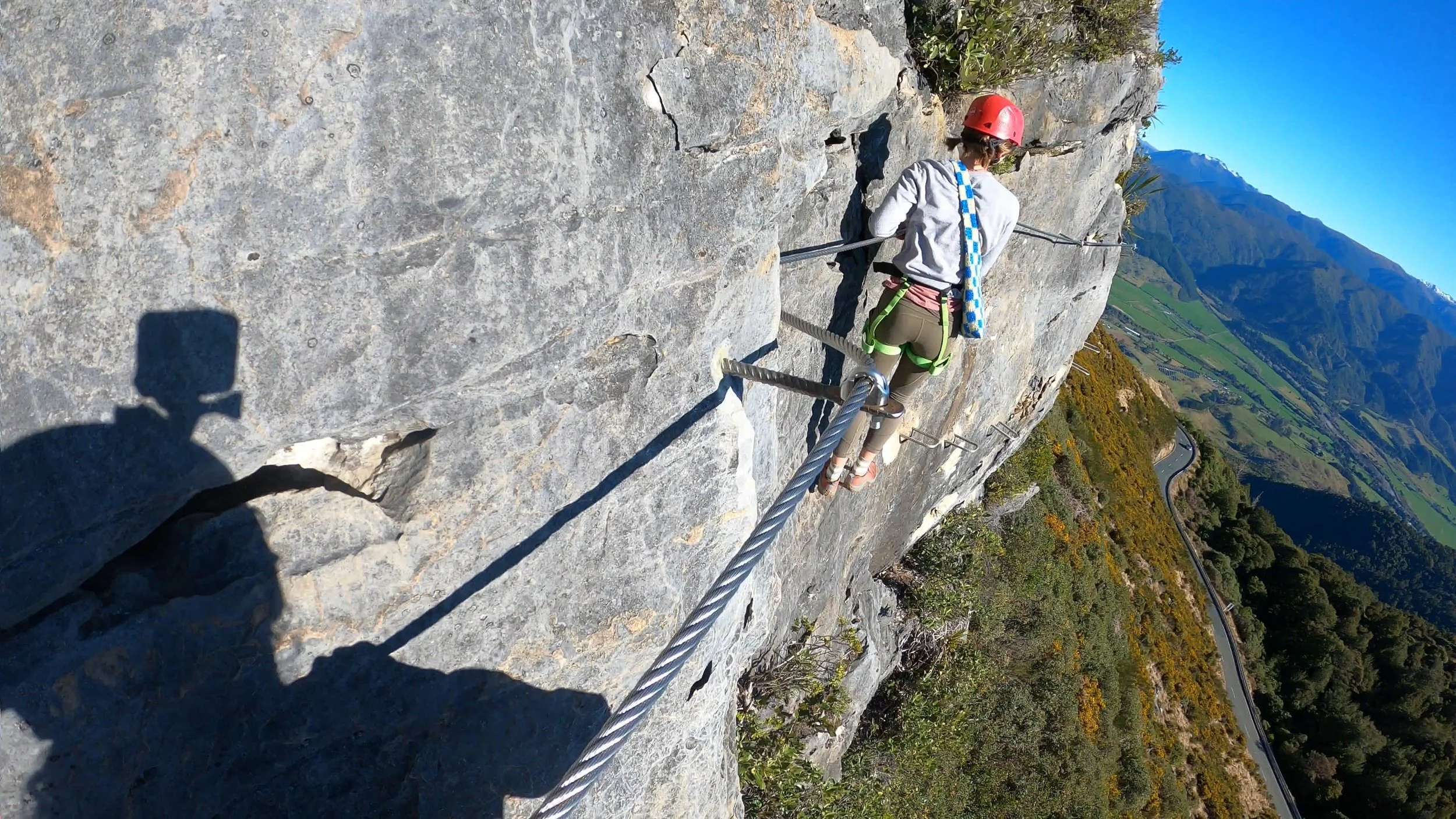 Our family climbing the Tākaka Hill Via Ferrata above the valley