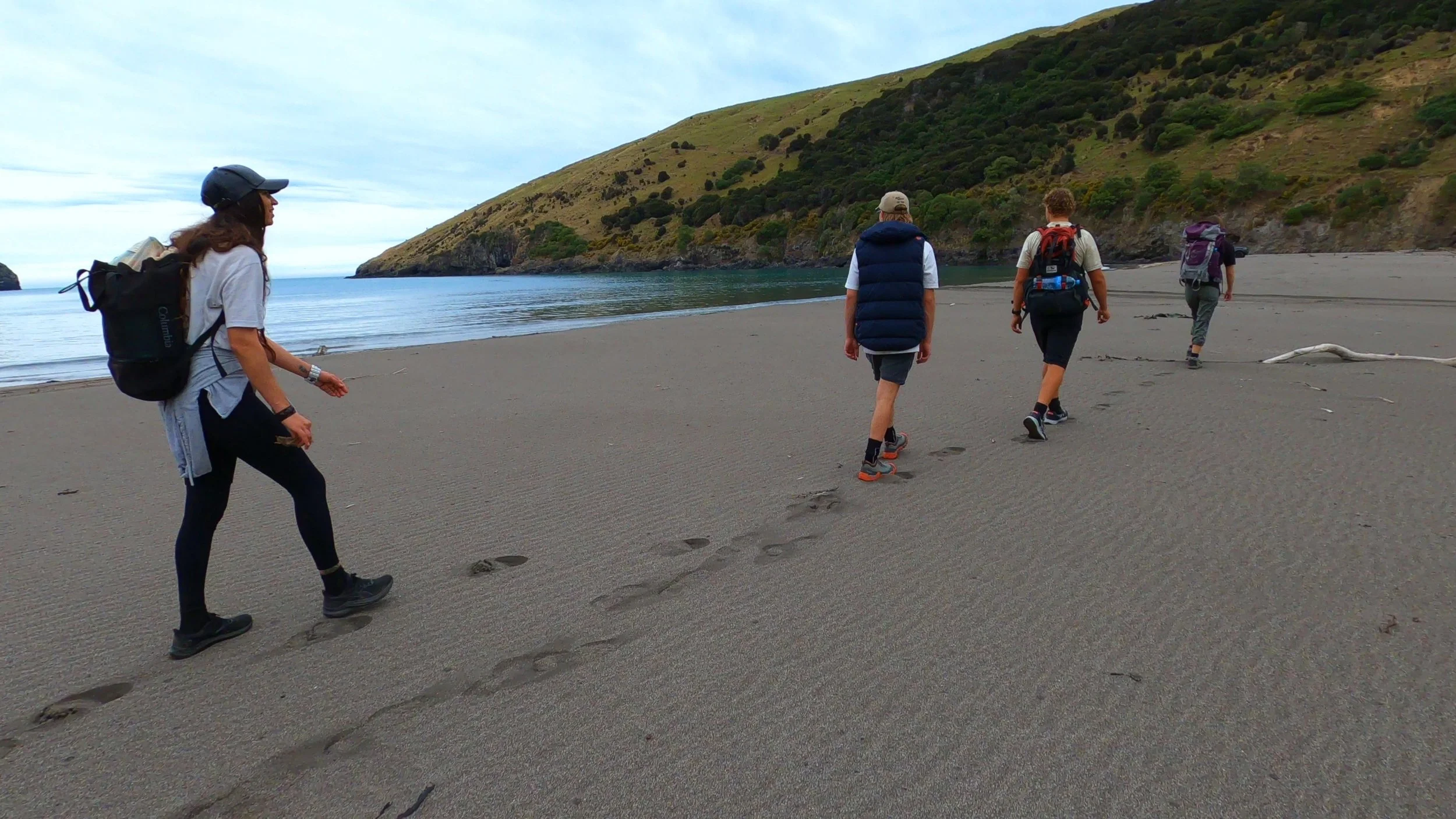 Walking along Ōtānerito Beach after hiking through Hinewai Reserve