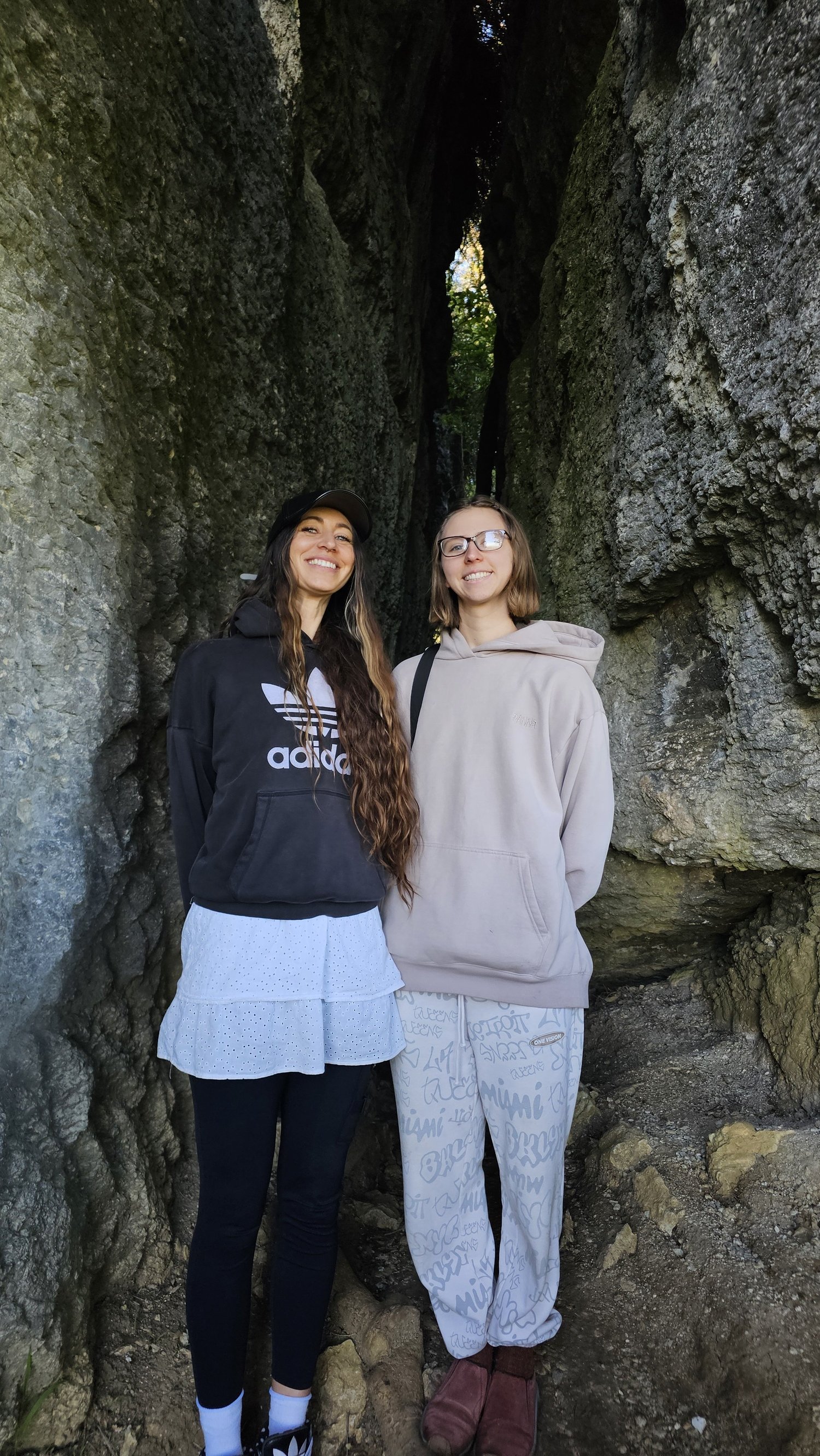 Family members standing between large limestone walls at The Grove Scenic Reserve