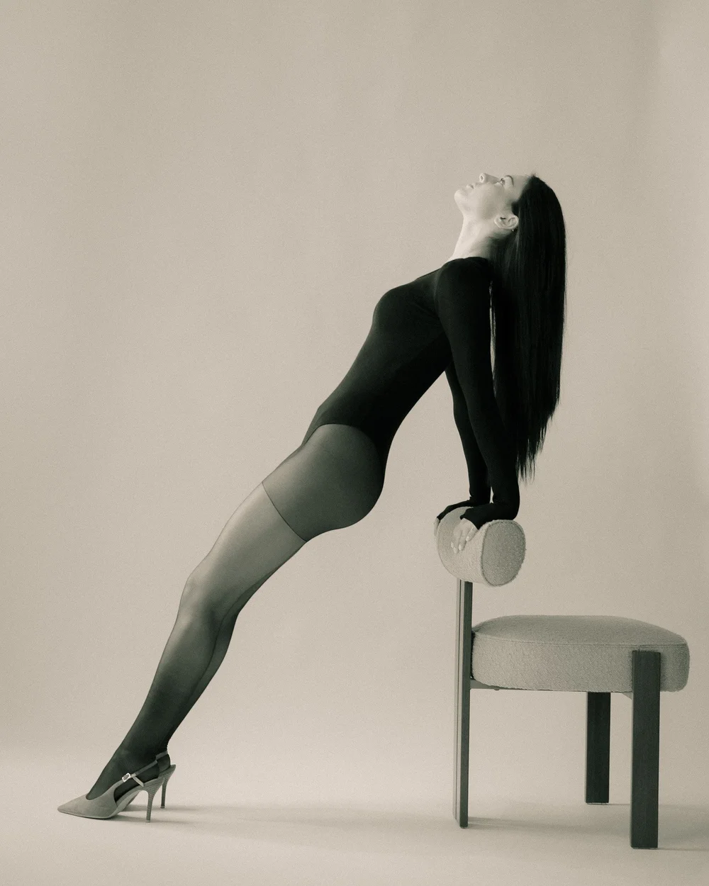 LILY × MINT — Black bodysuit, sculptural chair pose, photographed by CAMR Visuals.