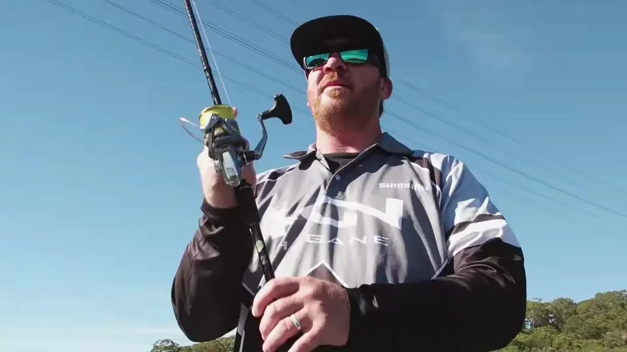 An angler using the Ultegra reel, viewed against the sky.