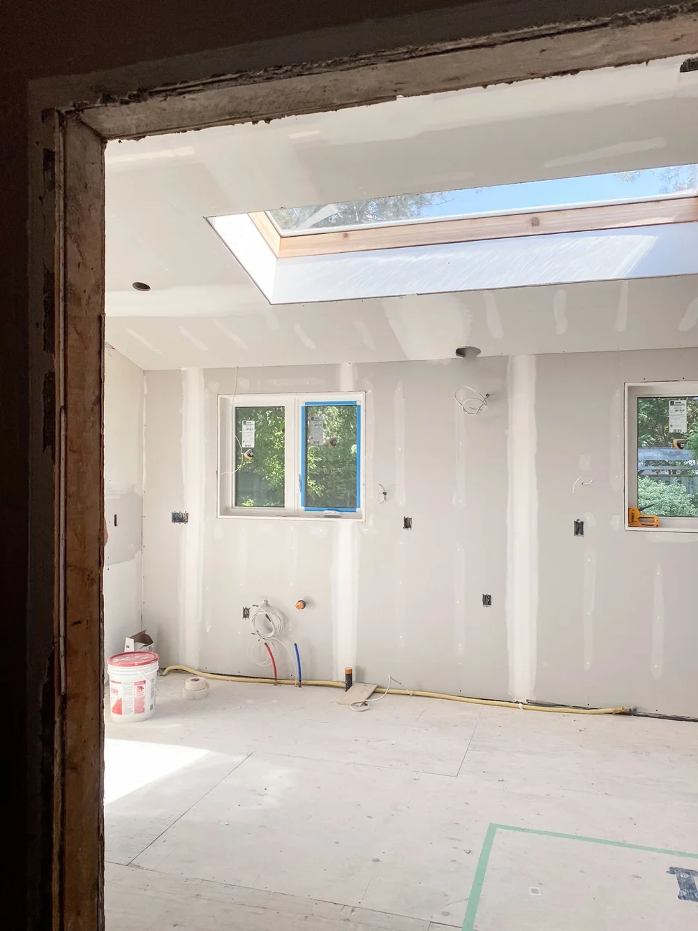 Drywall joint compound on walls and ceiling around the skylight