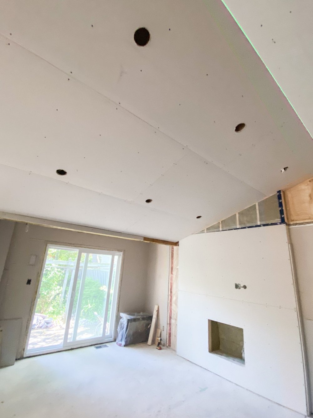 Ceiling drywall and fireplace wall with recessed-light openings