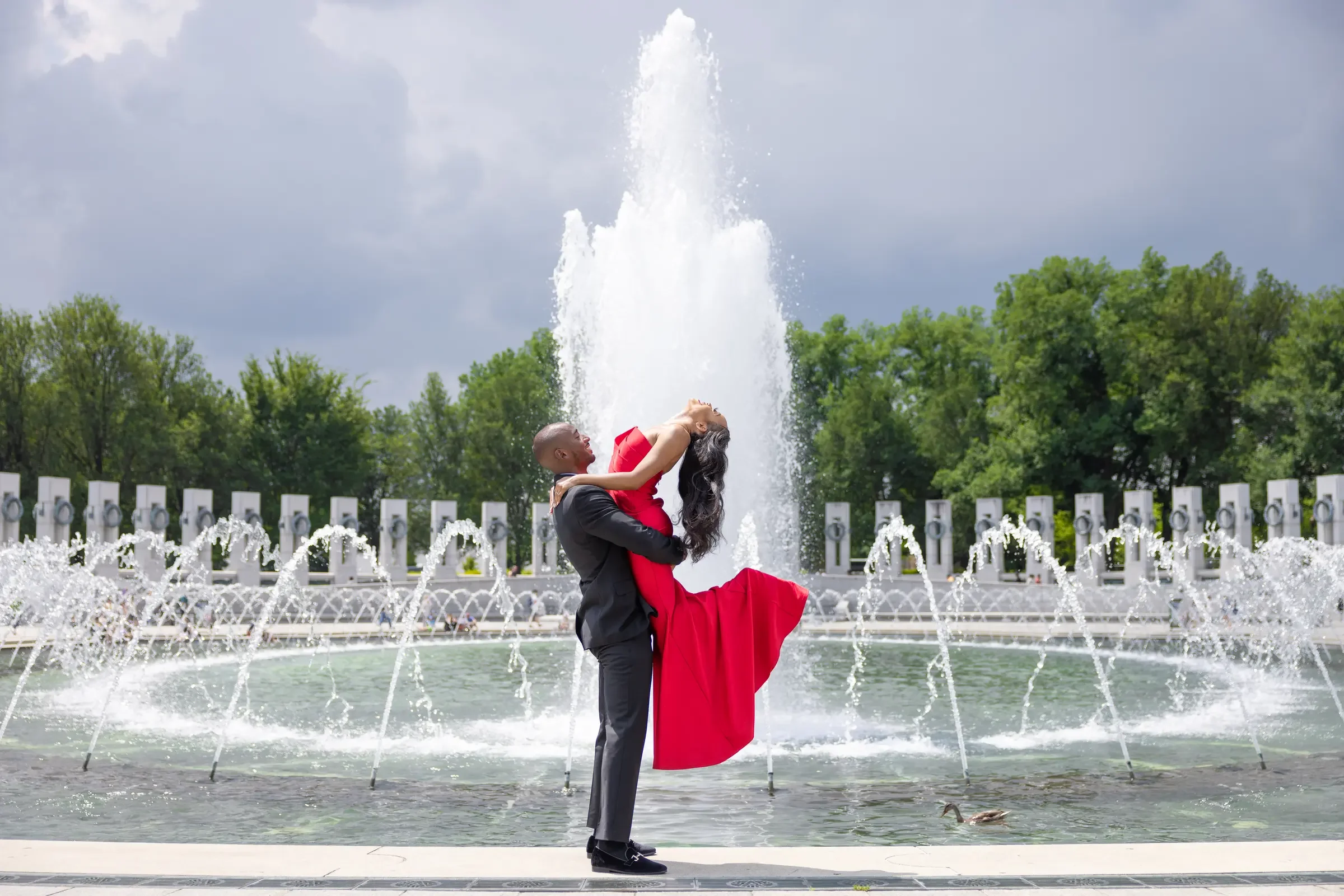 Ashley and Jahron sharing a dramatic portrait in front of a fountain