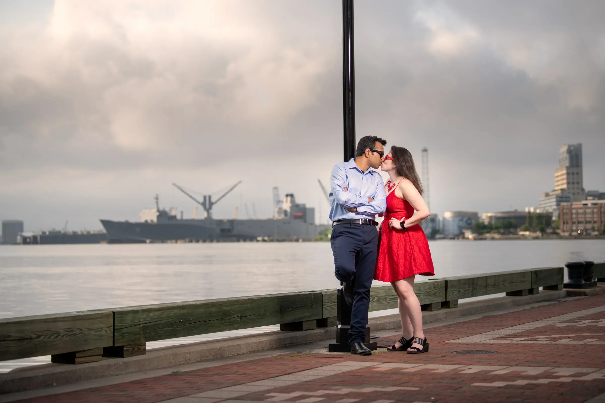 Mallory and Gabe sharing a waterfront kiss in Baltimore