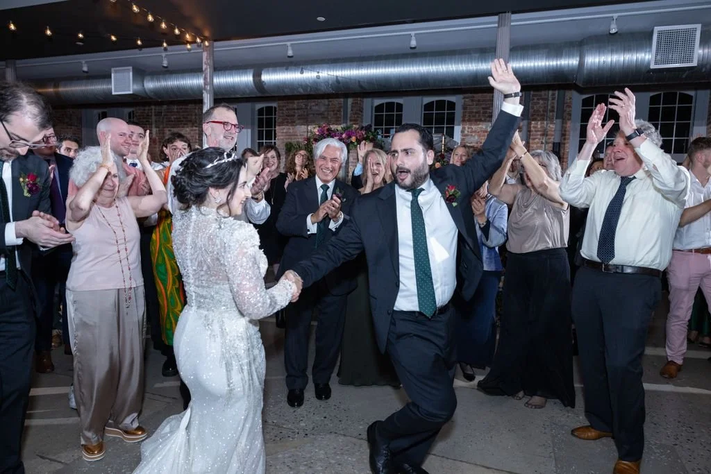 Newlyweds celebrating with guests on the dance floor