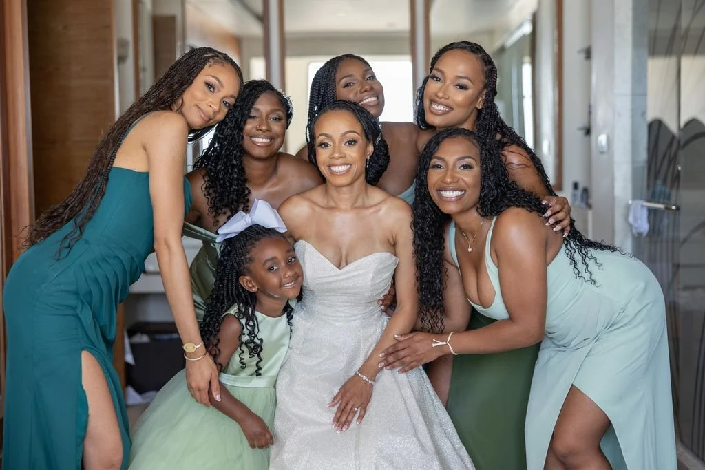 A bride surrounded by her wedding party at a destination wedding