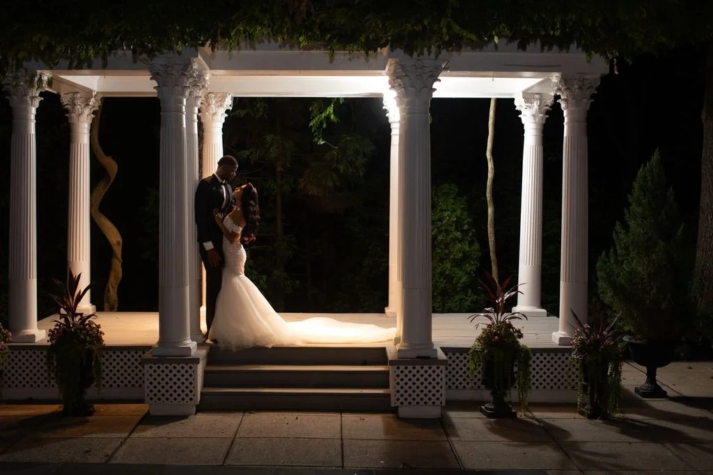 A wedding couple in a dramatic nighttime architectural portrait