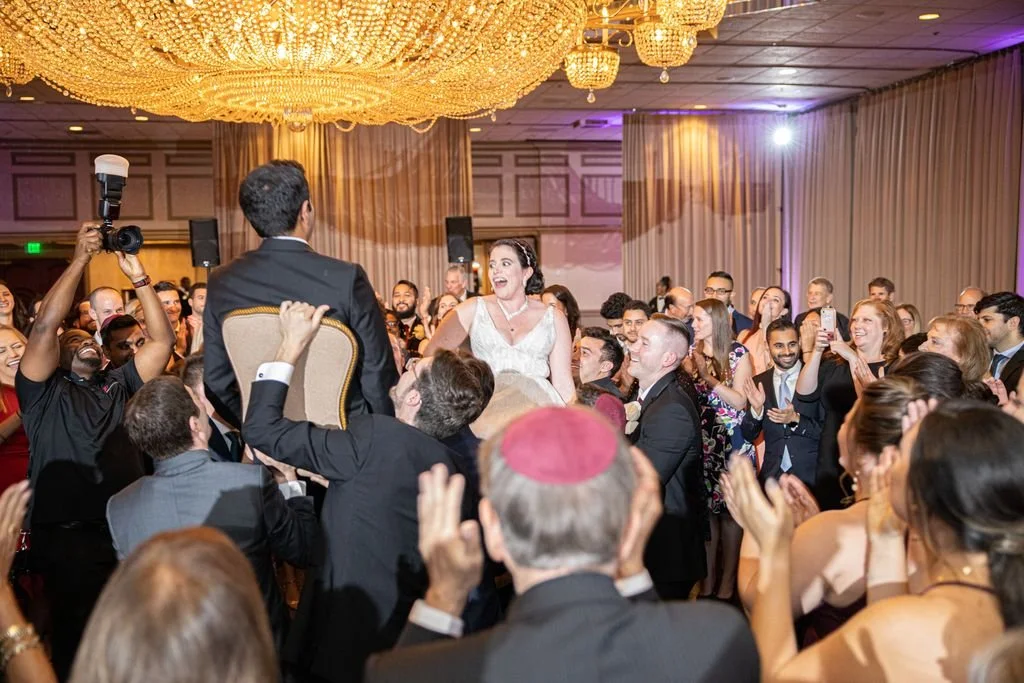 Wedding guests dancing together at the reception
