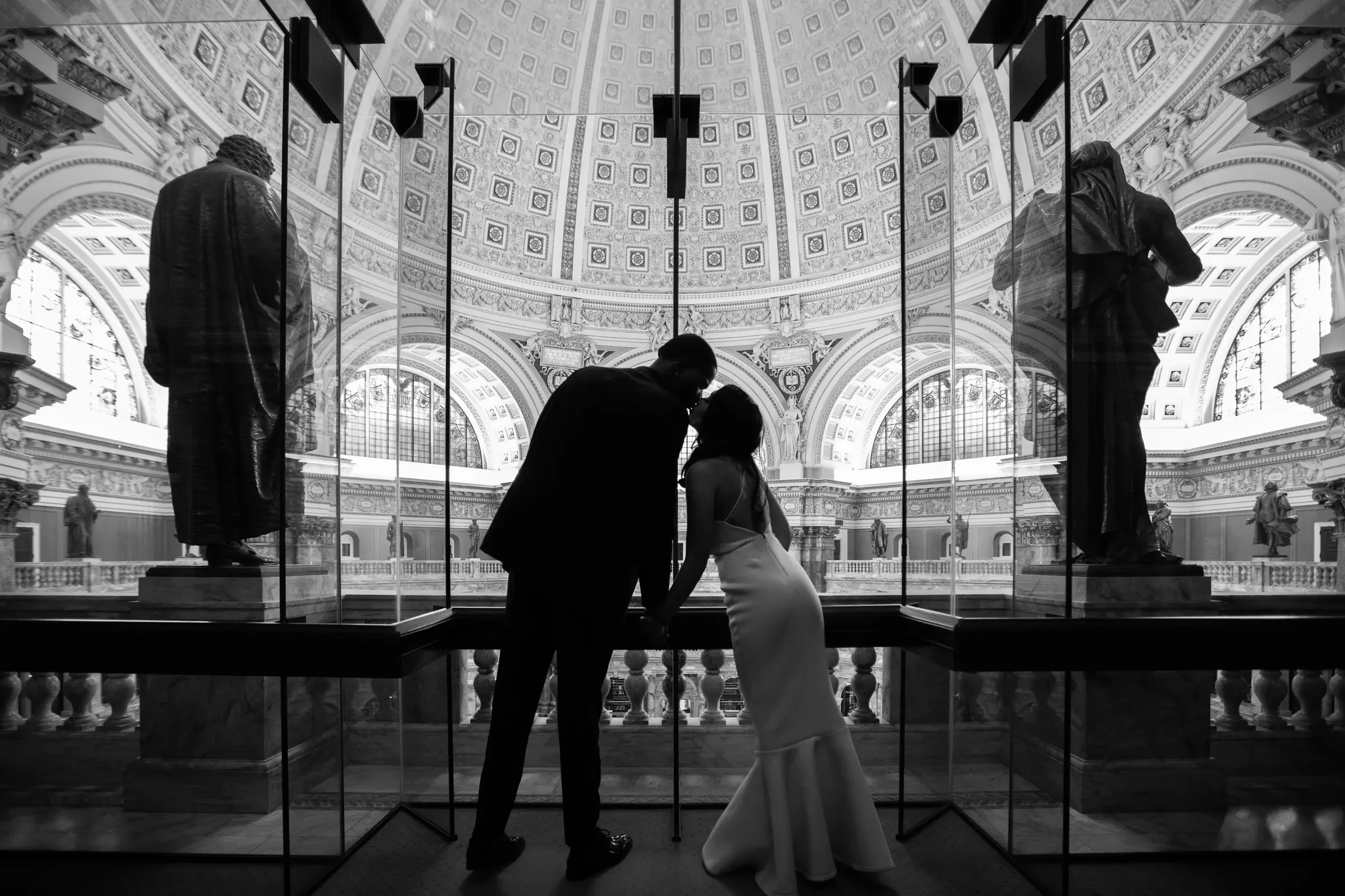 Alicia and Ted silhouetted within grand classical architecture