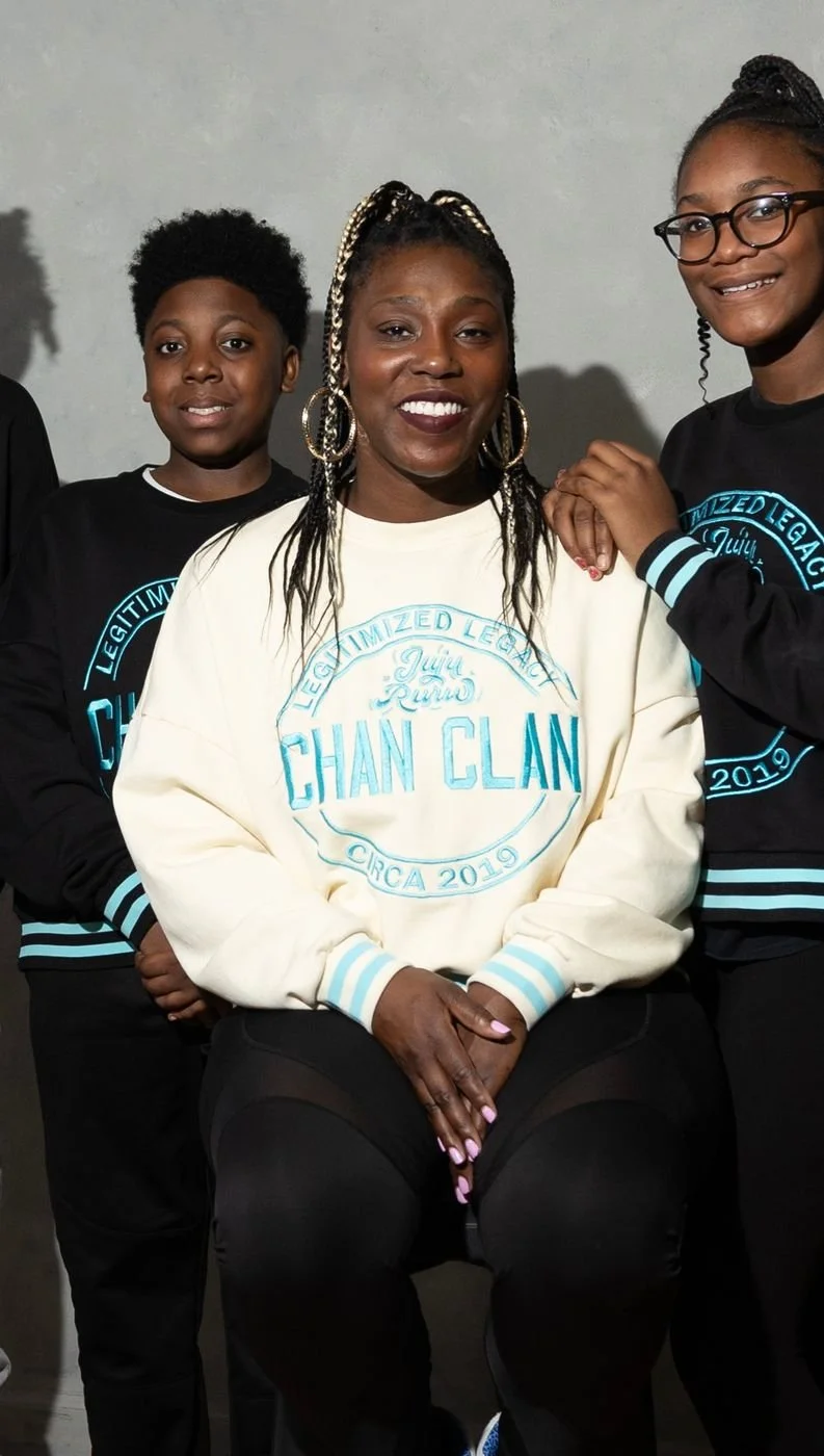 Zaria C. Chandler smiling in a cream Chan Clan crewneck