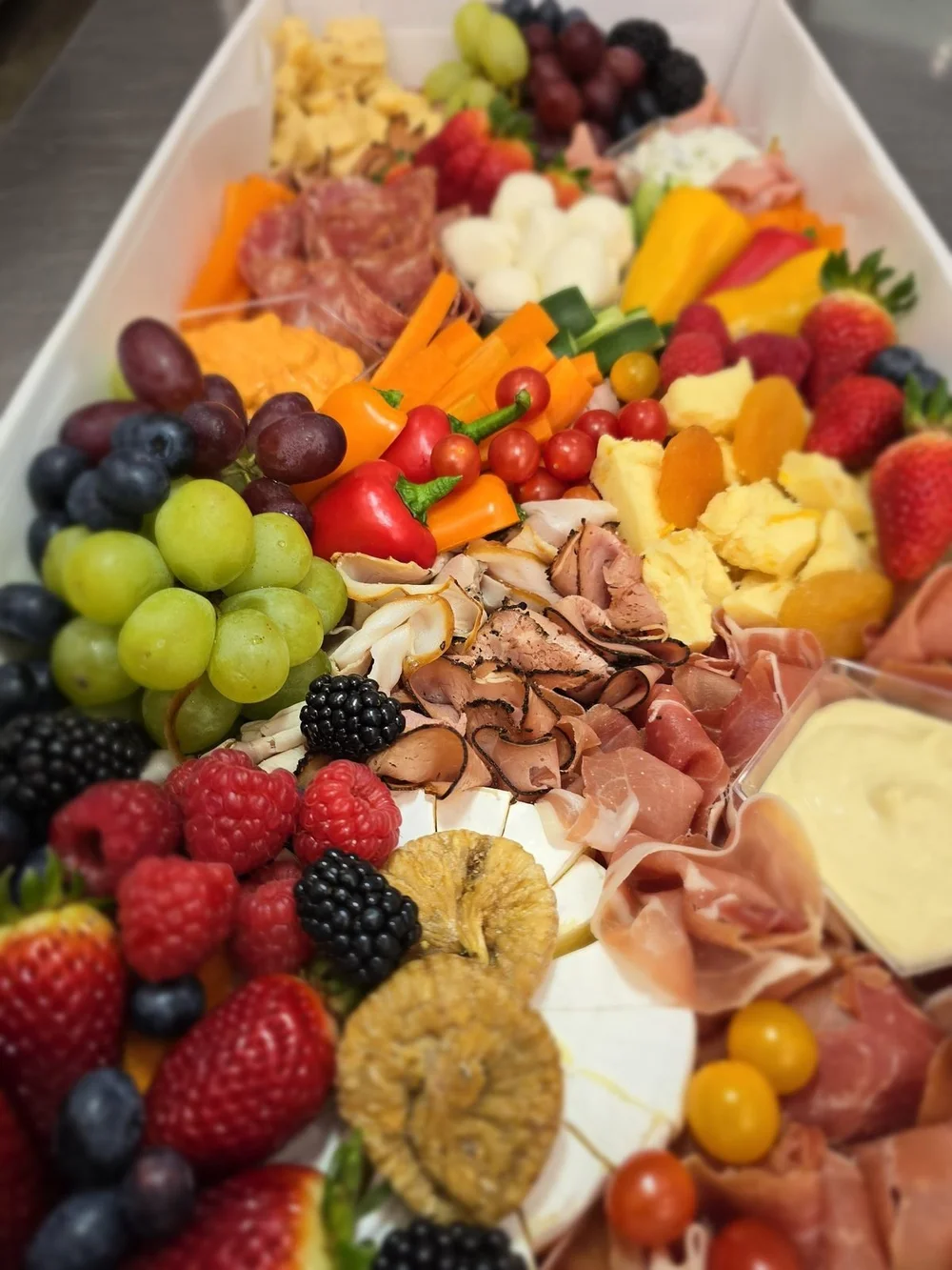 Grazing box with fruit, cured meats and cheeses