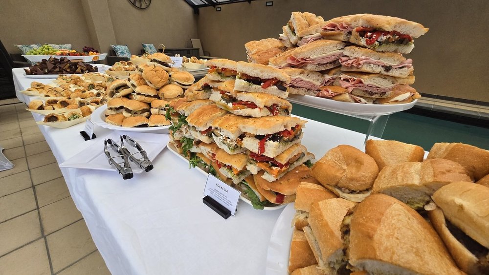 Stacked focaccia sandwiches and sliders by the pool