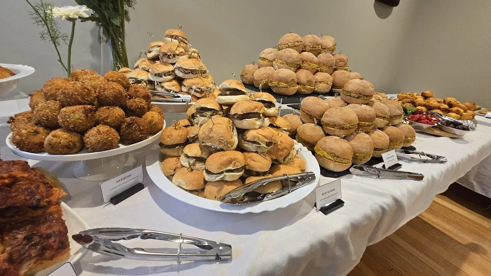 Arancini, beef sliders and veggie sliders on a buffet table