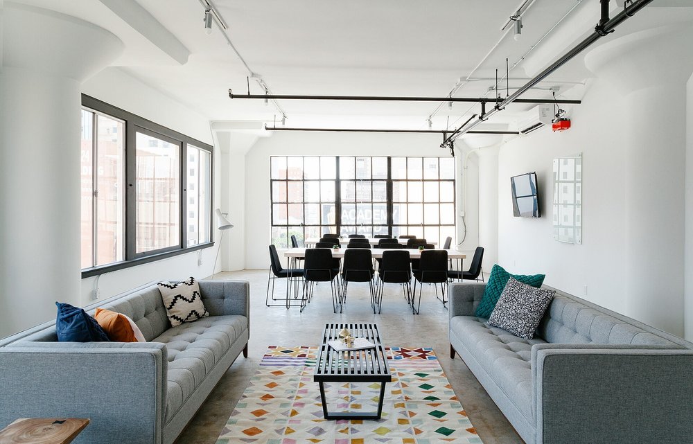 Open living area with sofas and large windows