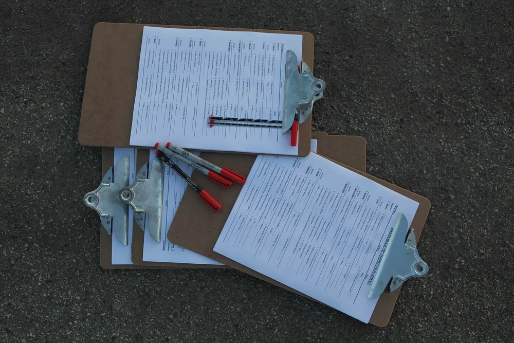Clipboards holding completed inspection checklists