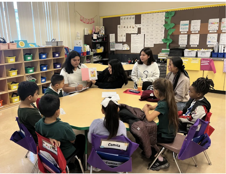 ARISE Education pathway intern reading with young students